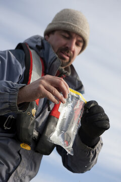 Scientist holding water sample in whirl pak
