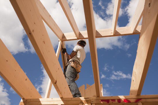 Carpenter adjusting roof rafters