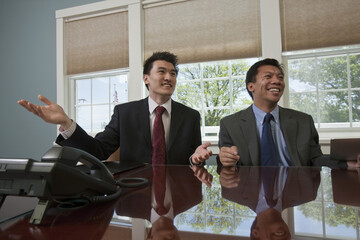 Businessmen sitting in their workplace together in a conference room