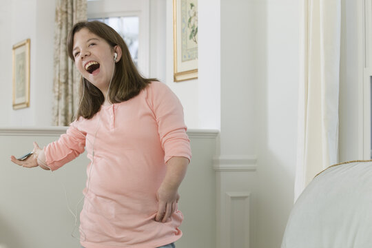 Teenage girl listening to an MP3 player in hand with birth defect