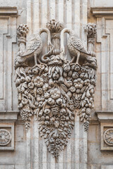 View of ancient stone carving decor of birds with a garland of fruits and vegetables on the facade of Hotel de Bagis aka Hotel de Clary or Hotel de pierre, Toulouse, France