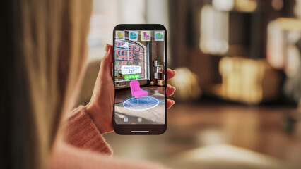 Decorating Apartment: Woman Holding Smartphone, using Augmented Reality Interior Design Software...