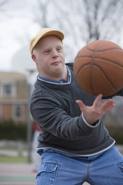 Man with Down Syndrome spinning basketball on his finger