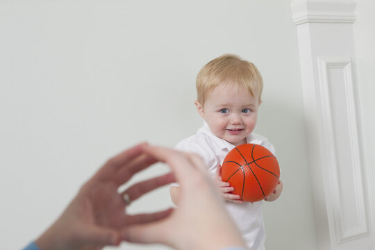 Woman signing the word 'Ball' in American Sign Language while communicating with her son