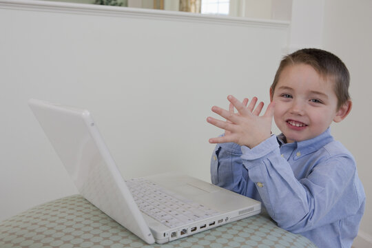 Boy signing the word 'Clap' in American Sign Language