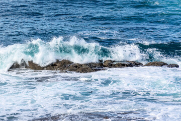 waves crashing against the rocks in the atlantic ocean in the town of Baiona, Galicia, Spain