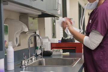Female nurse wiping her hands after wash