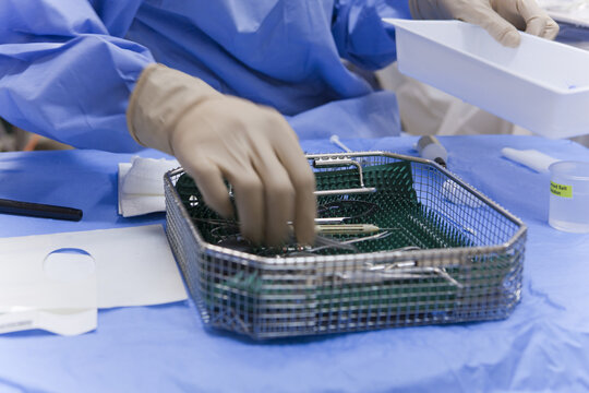 Surgical technologist cleaning the back table