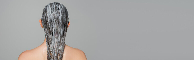 back view of young woman with bare shoulders and mask on wet hair isolated on grey, banner
