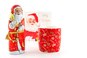 Chocolate Santa and Christmas mug with Christmas card in background