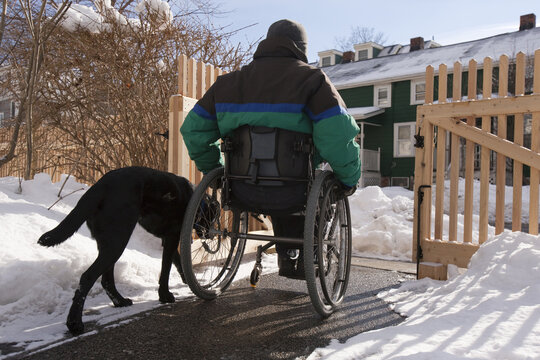 Woman with multiple sclerosis leaving home with a service dog