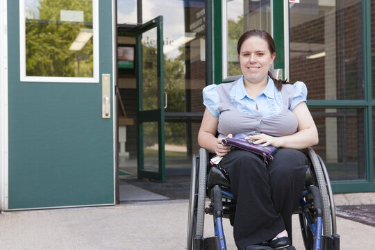 Student in wheelchair with Spina Bifida exiting the school
