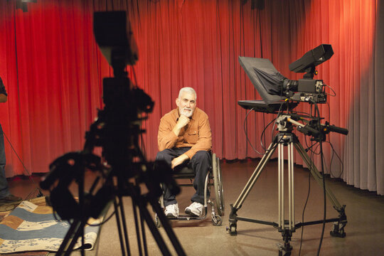 Announcer with muscular dystrophy relaxing in TV studio