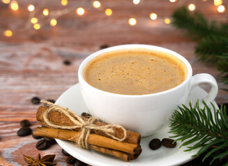 Cup of aromatic coffee on a wooden table. Christmas morning. Holiday. Close-up. Copy space. Selective focus.