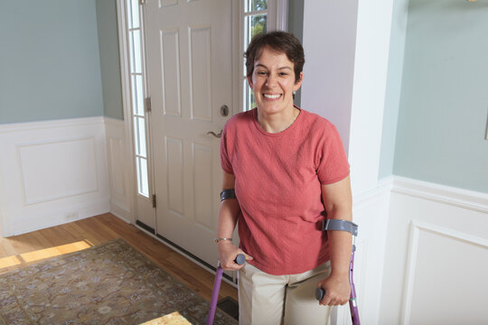 Woman with cerebral palsy smiling in her home