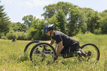 Man with spinal cord injury riding on off-road hand cycle