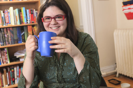Woman with Asperger's syndrome relaxing with a mug of tea
