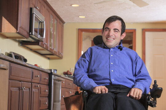 Man with Cerebral Palsy in his motorized wheelchair in his kitchen