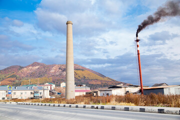 factory in the town against the background of mountains
