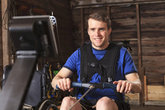 Man with spinal cord injury using his rowing machine