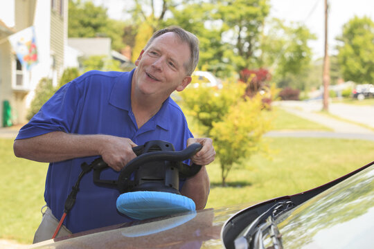 Man with Cerebral Palsy and dyslexia buffing his car