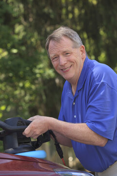 Man with Cerebral Palsy and dyslexia buffing his car