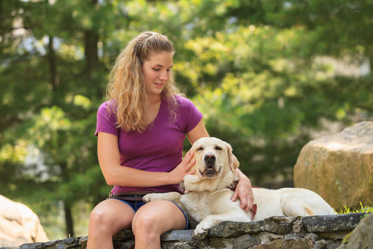 Woman with visual impairment relaxing with her service dog