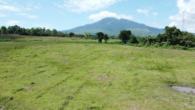 The view from the drone of Mount Seulawah Agam, green expanse of grass and trees.