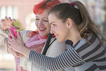 Blind young women using assistive technology on their cell phones