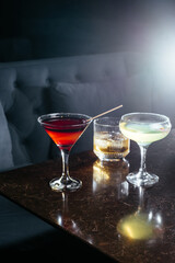 alcoholic cocktails on the stone table in the bar