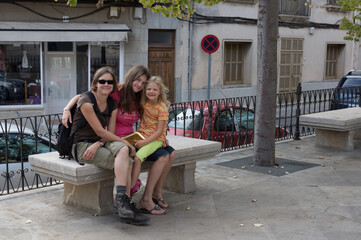 Obraz na płótnie Canvas Mutter mit Töchtern auf der Bank
