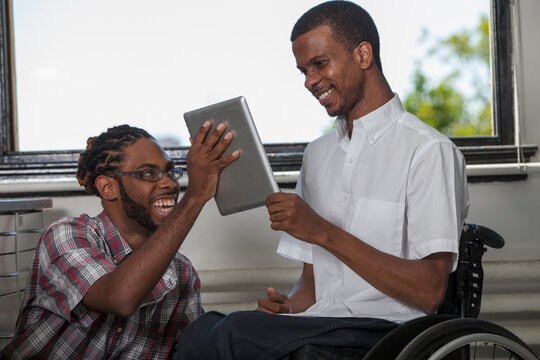 Two students who had Spinal Meningitis looking at the data on a tablet