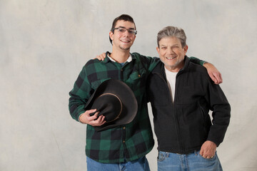 Portrait of a young man with autism and his mentor smiling