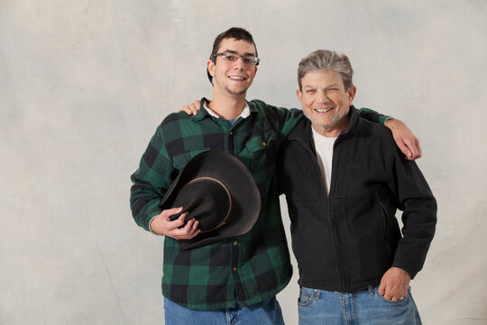Portrait of a young man with autism and his mentor smiling
