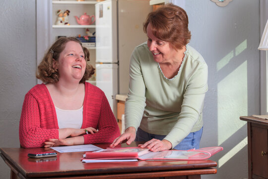 Mother helping daughter with Autism fill out job application