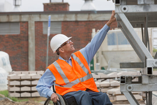 Project Engineer With A Spinal Cord Injury In A Wheelchair At Job Site