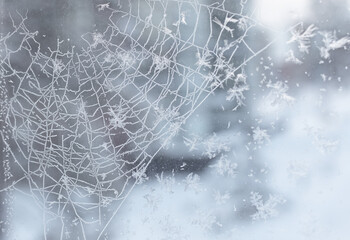 frozen snow-covered window, snow web and snowflakes, winter background, abstract background texture