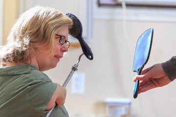 Woman with TAR Syndrome using an attachment to brush her hair