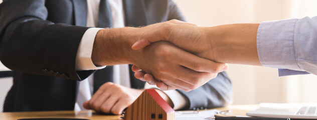 Close up hand of asian young male new landlord, tenant or rental handshake with home, apartment...