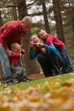 Family playing in a park with a deaf son