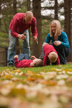 Family playing in a park with a deaf son
