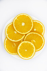 Sliced orange slices on a white plate. Orange slices on a white background. Oranges close-up.