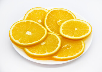 Fototapeta na wymiar Sliced orange slices on a white plate. Orange slices on a white background. Oranges close-up.
