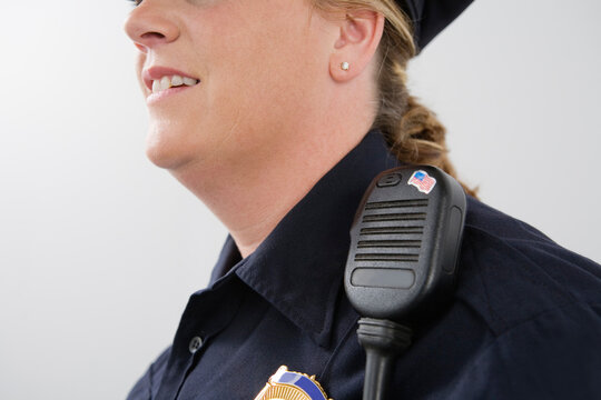 Close up of hand mike on a police woman's shoulder.