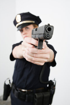 View of a police woman aiming with pistol.
