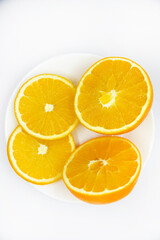 Sliced orange slices on a white plate. Orange slices on a white background. Oranges close-up.