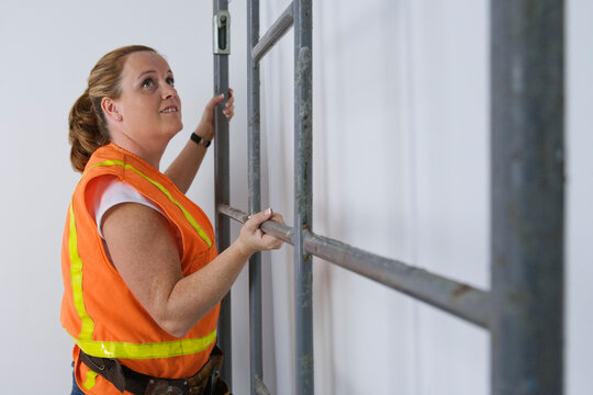 View of woman holding metal frame.
