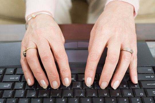 Close up of a mature woman using a laptop.