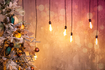 Christmas tree decorated with crafts and toys against a structural wall. Christmas card with Viva Magenta lights and Edison bulbs. Festive postcard Christmas background