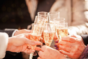 selective focus.  a glass of champagne in the hand of people and relatives at the Christmas party. Wedding party with champagne. People hold glasses of champagne in their hands at a holiday party. 